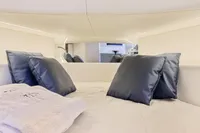 Luxurious interior of 2021 Seanfinity T4 yacht with plush pillows and elegant bedding.