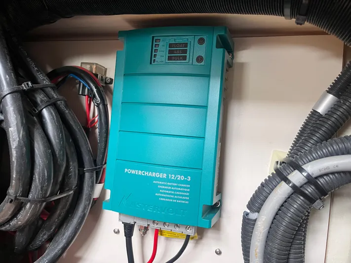 Obatanga Yacht Photos Pics Powercharger 12/20-3 installed in 2014 Hanse 345 yacht, surrounded by cables.