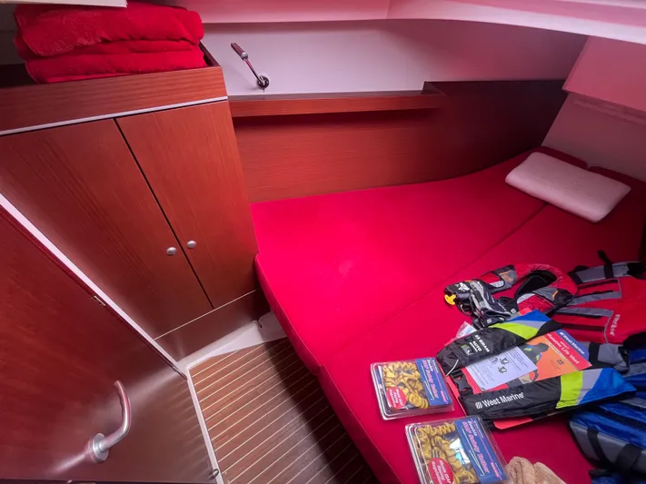 Obatanga Yacht Photos Pics Cozy cabin interior of 2014 Hanse 345 yacht with red bedding and nautical gear.
