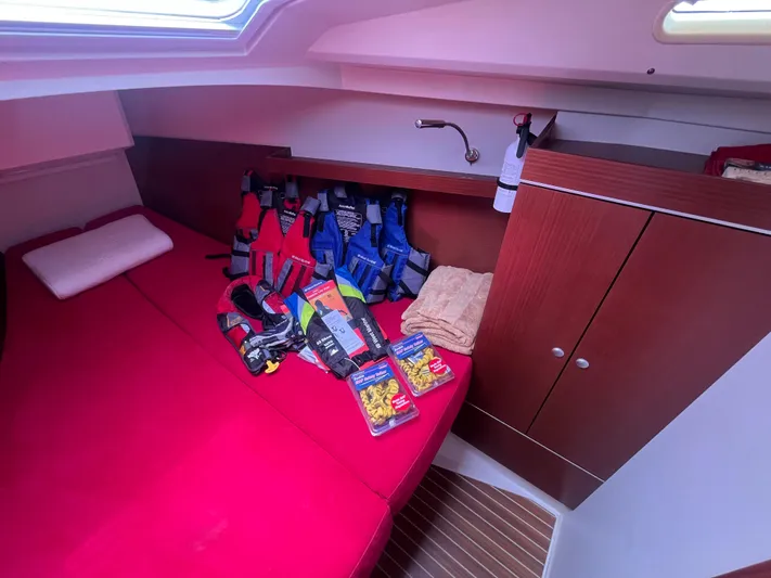 Obatanga Yacht Photos Pics Cozy cabin interior of 2014 Hanse 345 yacht with red bedding and safety gear.