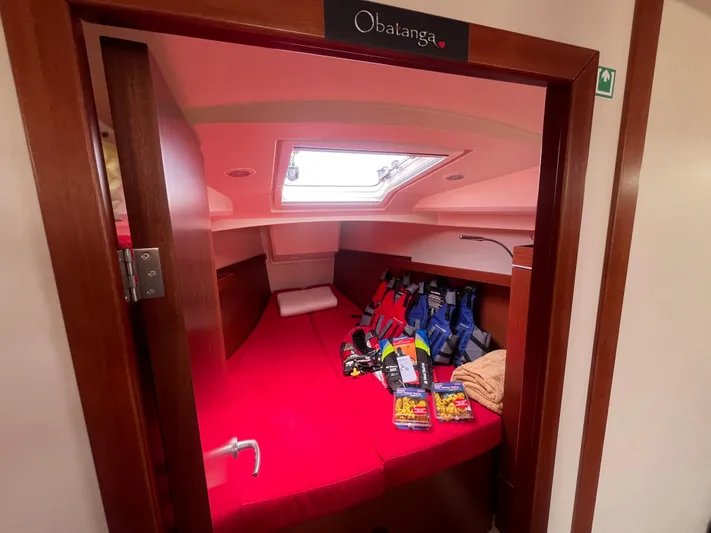 Obatanga Yacht Photos Pics Cozy cabin interior of 2014 Hanse 345 sailboat with red bedding and life jackets.