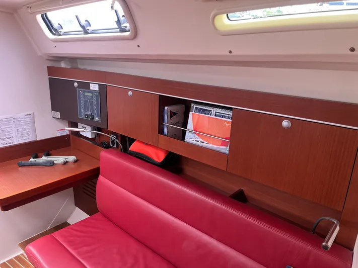 Obatanga Yacht Photos Pics Interior of 2014 Hanse 345 yacht with red seating and wooden cabinetry.