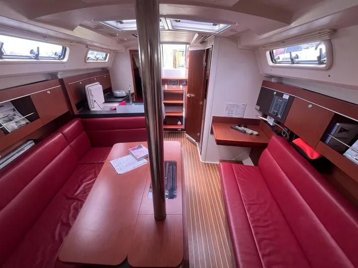 Obatanga Yacht Photos Pics Interior of 2014 Hanse 345 sailboat with red seating and wooden accents.