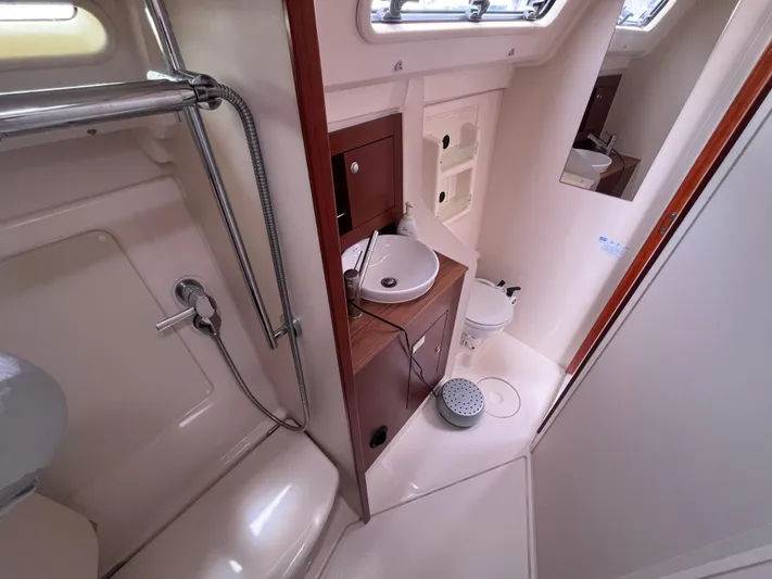 Obatanga Yacht Photos Pics Compact bathroom in a 2014 Hanse 345 yacht with shower, sink, and toilet.