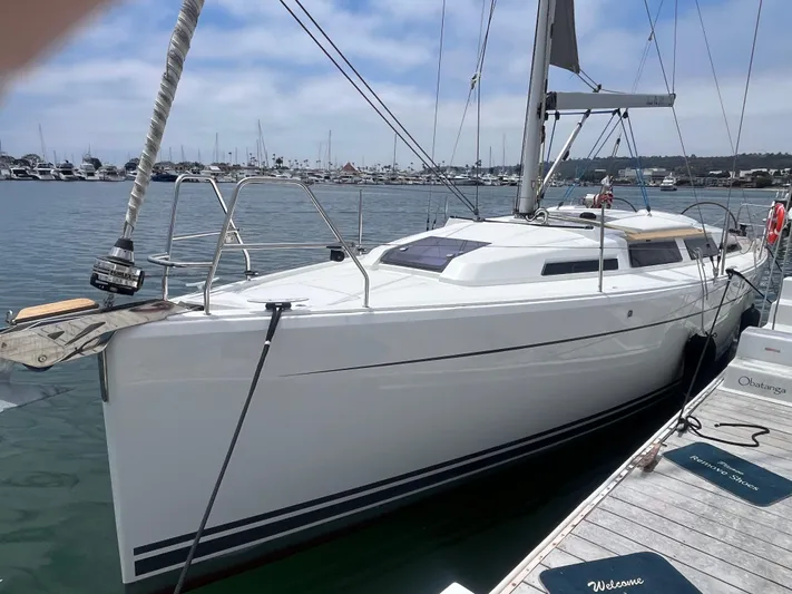 Obatanga Yacht Photos Pics 2014 Hanse 345 sailboat docked in a marina, clear sky, calm water.