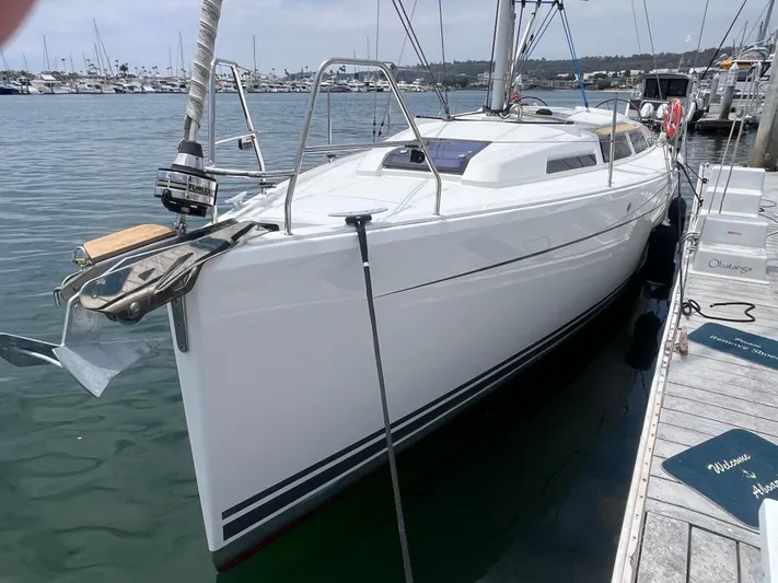 Obatanga Yacht Photos Pics 2014 Hanse 345 sailboat docked at marina, sleek white hull, calm water background.