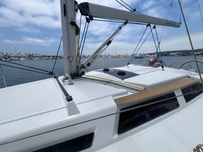 Obatanga Yacht Photos Pics Sailing yacht Hanse 345, 2014 model, docked in a marina under a partly cloudy sky.