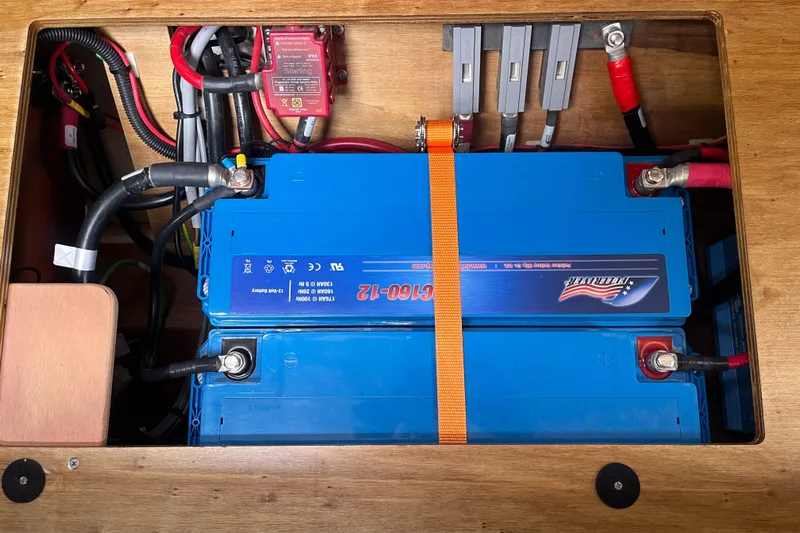 Obatanga Yacht Photos Pics Battery compartment of a 2014 Hanse 345 yacht with blue batteries and wiring.