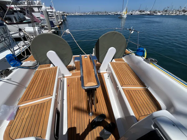 Obatanga Yacht Photos Pics 2014 Hanse 345 yacht deck with wooden seating, docked in a marina.