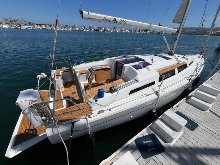 Obatanga Yacht Photos Pics 2014 Hanse 345 sailboat docked at marina, featuring sleek design and wooden deck accents.