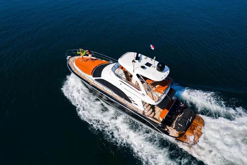  Yacht Photos Pics 2005 Sea Ray Sedan Bridge 520 yacht cruising on open water, aerial view.