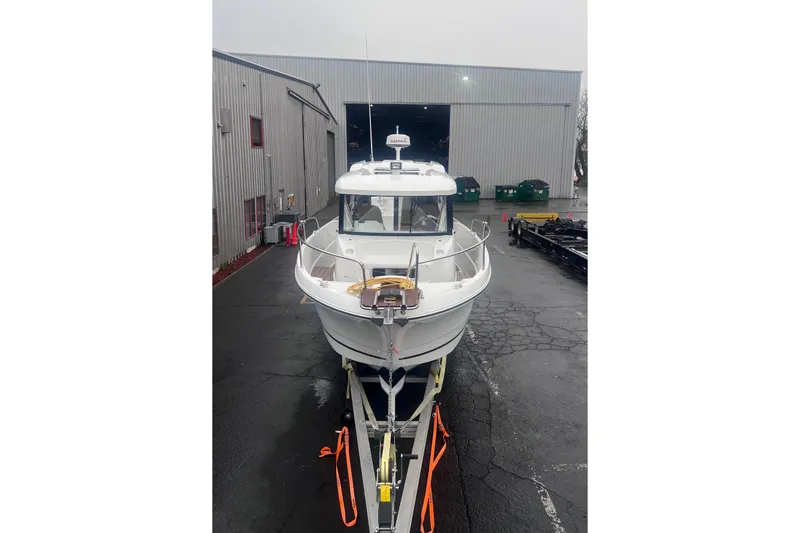  Yacht Photos Pics 2015 Jeanneau Merry Fisher 855 Marlin boat on trailer outside warehouse.