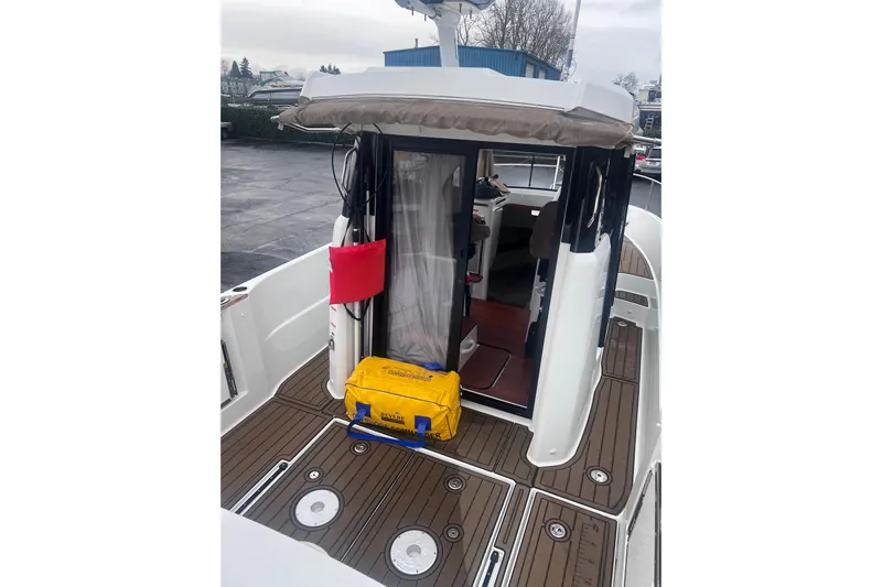  Yacht Photos Pics 2015 Jeanneau Merry Fisher 855 Marlin boat deck with open cabin door.