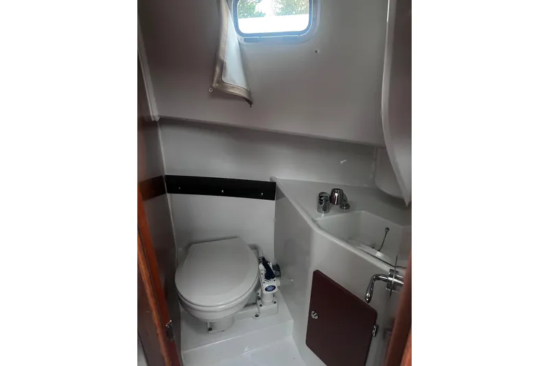  Yacht Photos Pics Bathroom interior of 2015 Jeanneau Merry Fisher 855 Marlin boat, featuring toilet and sink.