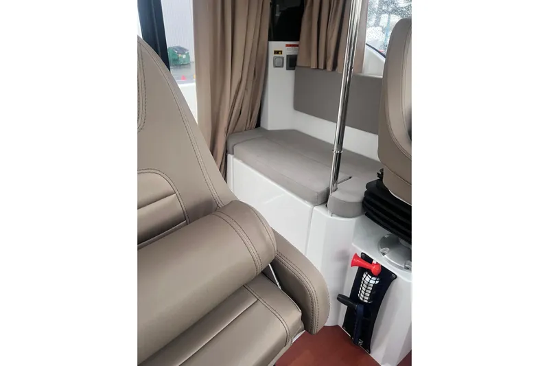  Yacht Photos Pics Interior of 2015 Jeanneau Merry Fisher 855 Marlin with beige seating and curtains.