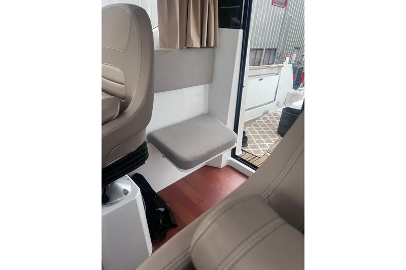  Yacht Photos Pics Interior of 2015 Jeanneau Merry Fisher 855 Marlin, featuring seating and open door.