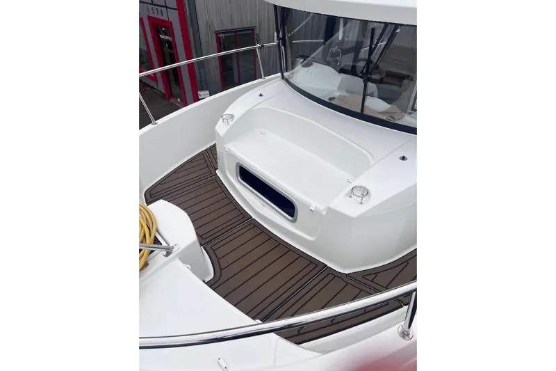  Yacht Photos Pics 2015 Jeanneau Merry Fisher 855 Marlin boat deck with wood finish and railing.