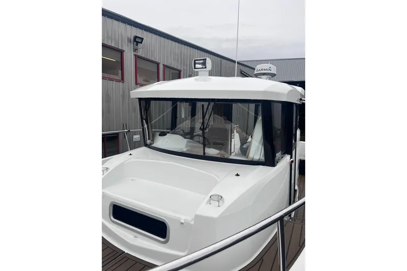  Yacht Photos Pics 2015 Jeanneau Merry Fisher 855 Marlin boat docked near a building.