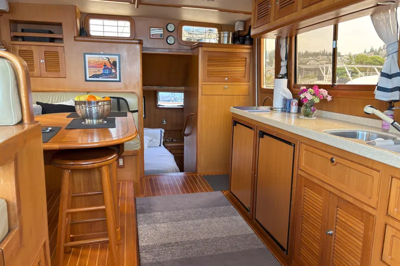 Slainte Yacht Photos Pics Interior of 2006 Selene 40 Archer yacht with wooden cabinetry and cozy dining area.