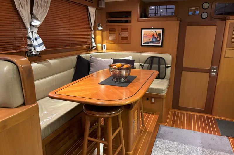 Slainte Yacht Photos Pics Cozy interior of 2006 Selene 40 Archer yacht with wooden dining area and seating.