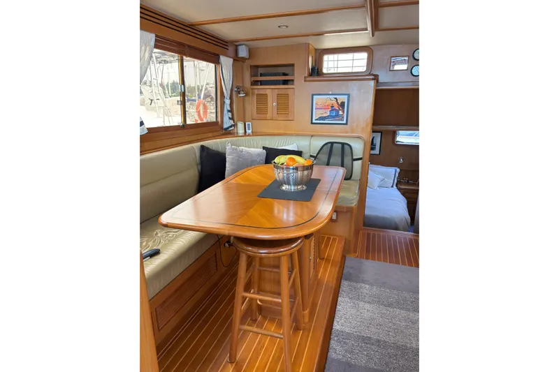 Slainte Yacht Photos Pics Interior of 2006 Selene 40 Archer yacht with wooden dining area and cozy seating.