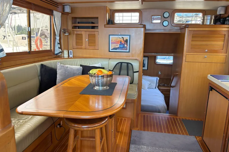 Slainte Yacht Photos Pics Luxurious interior of 2006 Selene 40 Archer yacht with dining area and cozy cabin.