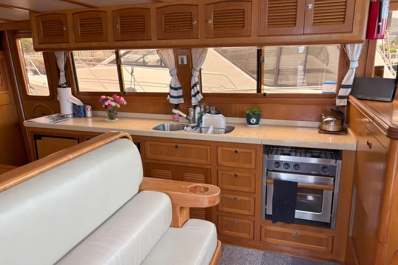 Slainte Yacht Photos Pics Luxurious 2006 Selene 40 Archer yacht kitchen with wooden cabinetry and modern appliances.