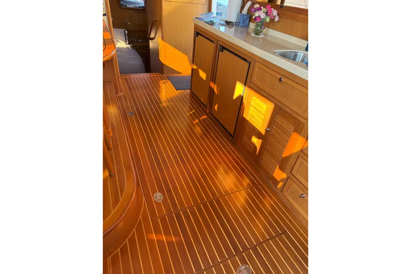 Slainte Yacht Photos Pics Luxurious wooden interior of 2006 Selene 40 Archer yacht, featuring elegant cabinetry and flooring.