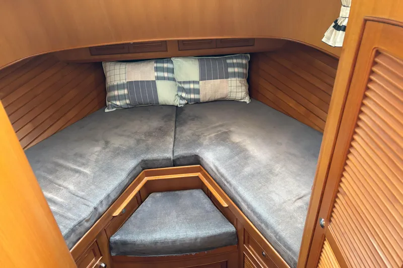 Slainte Yacht Photos Pics Cozy cabin interior of 2006 Selene 40 Archer yacht with plush bedding and wooden finish.