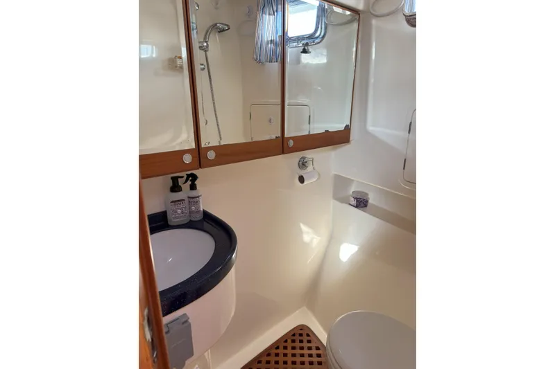 Slainte Yacht Photos Pics Bathroom interior of 2006 Selene 40 Archer yacht, featuring sink, mirror, and shower.