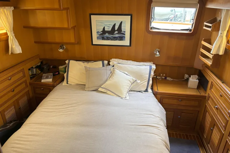Slainte Yacht Photos Pics Cozy cabin bedroom in 2006 Selene 40 Archer yacht with wooden interior and nautical decor.