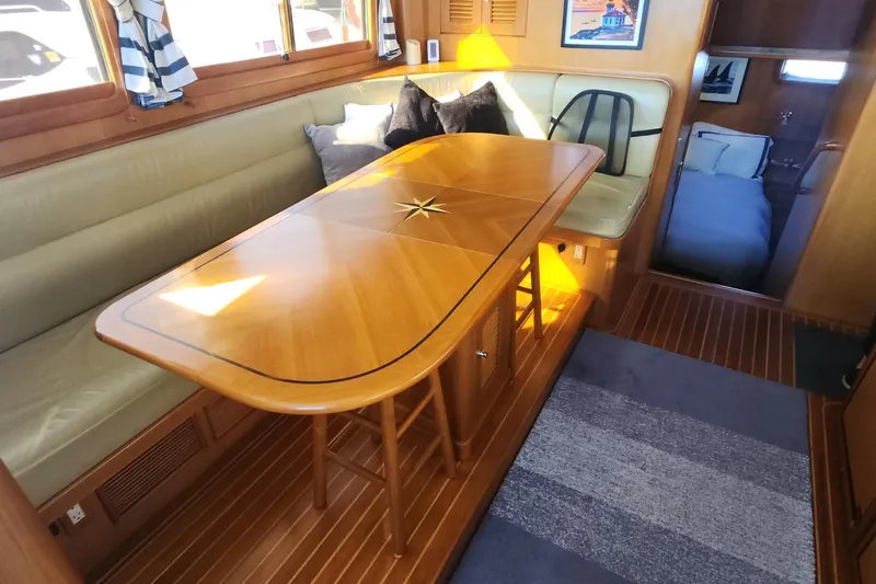 Slainte Yacht Photos Pics Luxurious interior of 2006 Selene 40 Archer yacht with elegant wooden dining area.