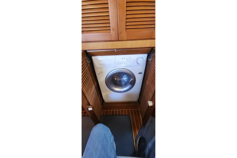 Slainte Yacht Photos Pics Washing machine inside 2006 Selene 40 Archer yacht with wooden cabinetry.