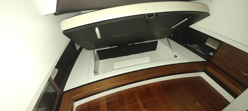  Yacht Photos Pics 2020 Pursuit S 368 Sport cabin interior with wooden flooring and storage compartments.