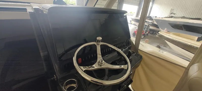  Yacht Photos Pics 2020 Pursuit S 368 Sport boat helm with steering wheel and control panel.