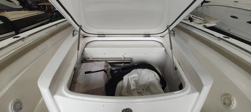  Yacht Photos Pics Open storage compartment on a 2020 Pursuit S 368 Sport boat, containing various items.