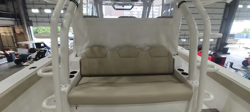  Yacht Photos Pics 2020 Pursuit S 368 Sport boat interior with beige seating in a garage setting.