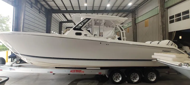  Yacht Photos Pics 2020 Pursuit S 368 Sport boat on trailer in a warehouse setting.
