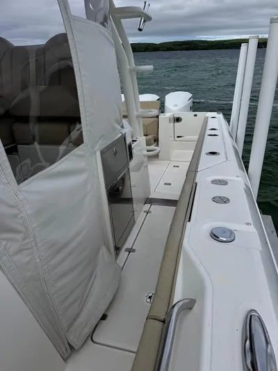  Yacht Photos Pics 2020 Pursuit S 368 Sport boat deck with seating and storage, on a lake.