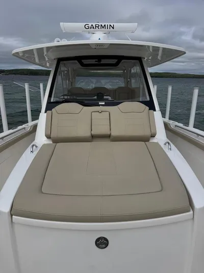  Yacht Photos Pics 2020 Pursuit S 368 Sport boat with Garmin equipment, featuring a spacious deck and seating area.