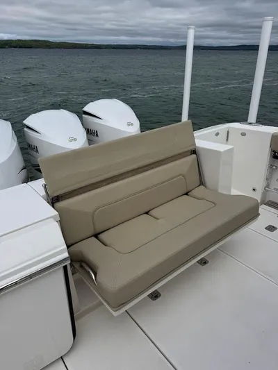  Yacht Photos Pics 2020 Pursuit S 368 Sport boat with beige seating and Yamaha engines on a lake.