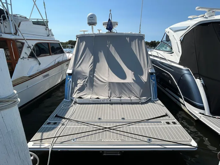  Yacht Photos Pics 2020 Formula 380 Super Sport Crossover boat docked with cover, surrounded by other boats.