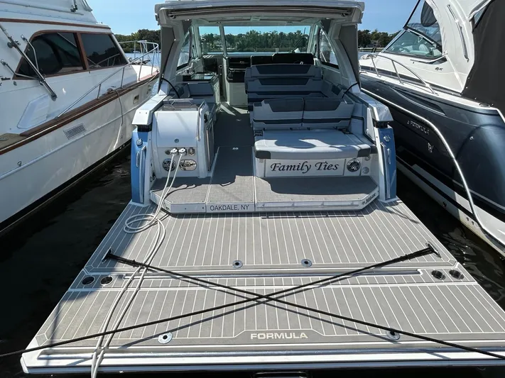  Yacht Photos Pics 2020 Formula 380 Super Sport Crossover boat docked, rear view with seating area.