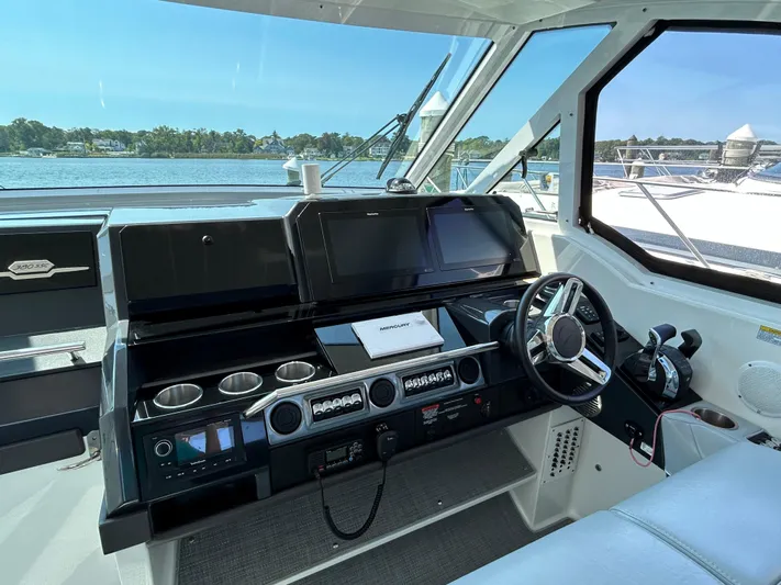  Yacht Photos Pics 2020 Formula 380 Super Sport Crossover helm with modern controls and scenic water view.