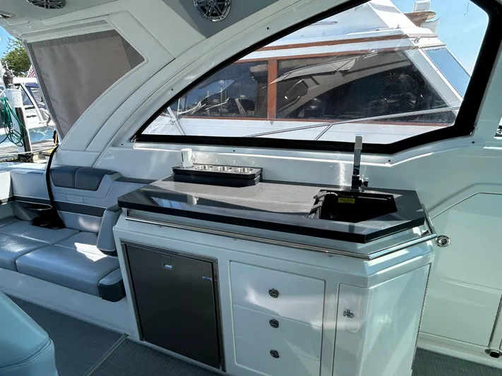  Yacht Photos Pics 2020 Formula 380 Super Sport Crossover interior with sleek kitchenette and seating area.