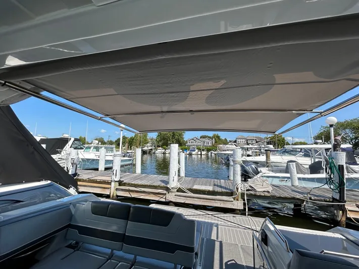  Yacht Photos Pics 2020 Formula 380 Super Sport Crossover at marina dock, featuring spacious seating and canopy.