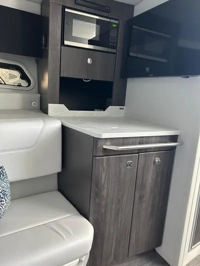  Yacht Photos Pics 2020 Formula 380 Super Sport Crossover interior with modern kitchenette and seating.