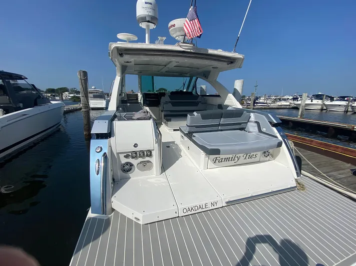 Yacht Photos Pics 2020 Formula 380 Super Sport Crossover boat docked, rear view with seating and American flag.