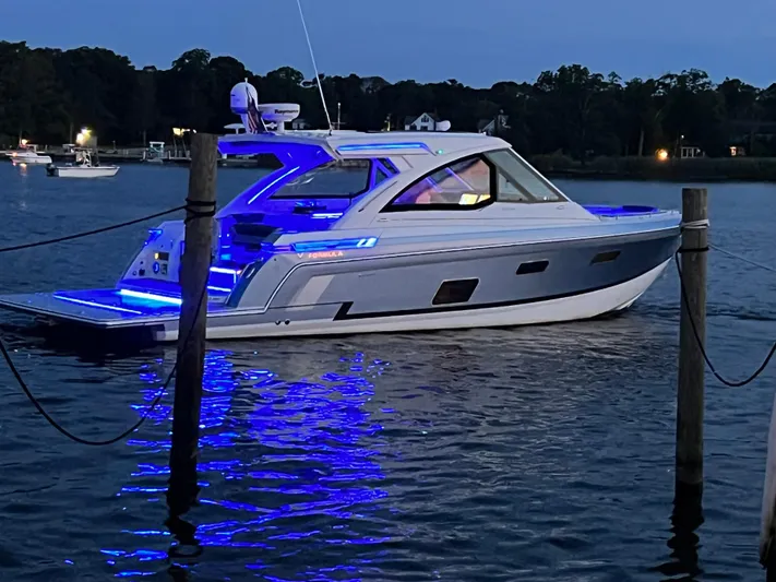  Yacht Photos Pics 2020 Formula 380 Super Sport Crossover yacht with blue LED lights at dusk.