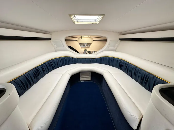  Yacht Photos Pics 2004 Donzi 38 ZX cabin interior with white and blue seating, skylight, and modern design.